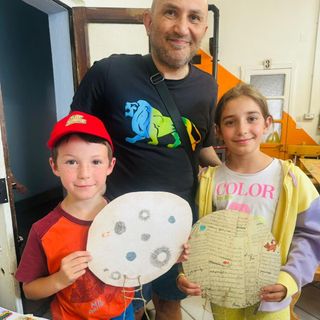 Roberto Pino con due dei bambini che hanno realizzato le decorazioni lunari per la nuova festa perosina