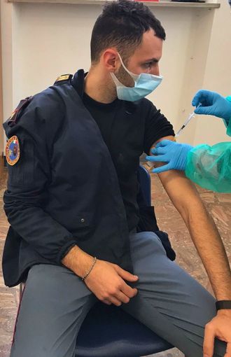 Un poliziotto si sottopone al vaccino Astrazeneca