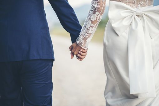 due sposi si tengono per mano