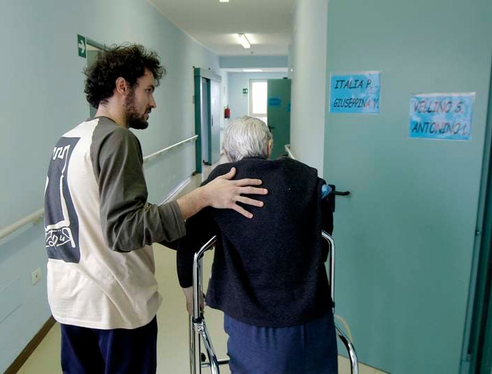 persona anziana assistita da un ragazzo giovane
